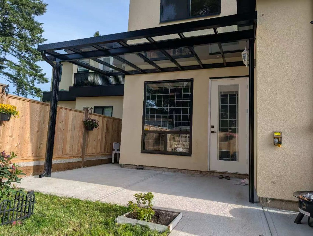 Glass patio cover connecting to rear doors on a Richmond-area style home